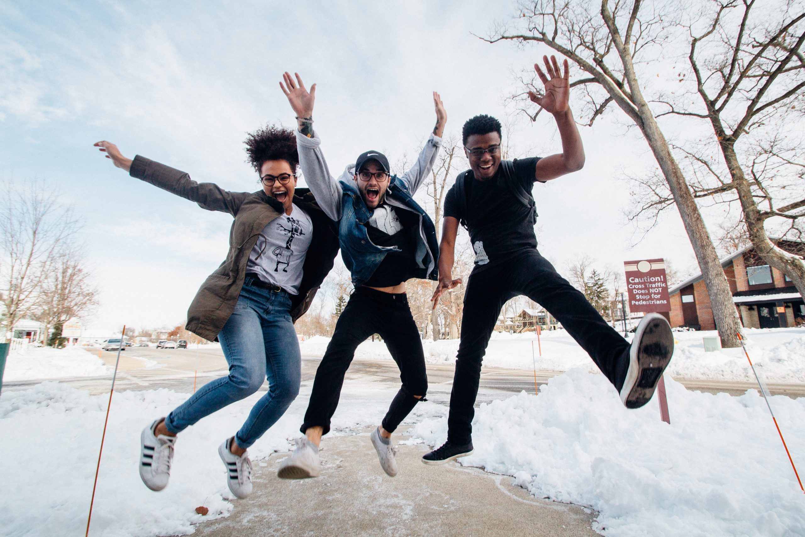 Three youth jumping for joy