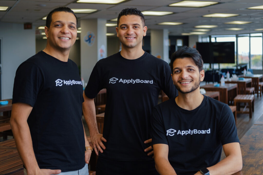 three people posing in a office setting