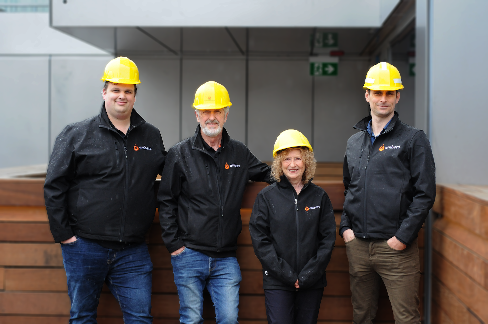 4 people posing with hard hats