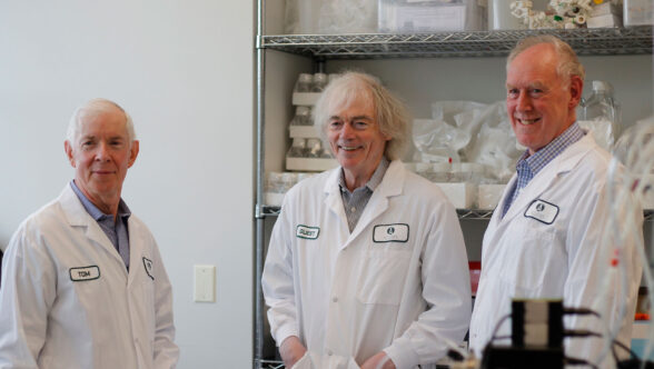 three people dressed in lab coats posing