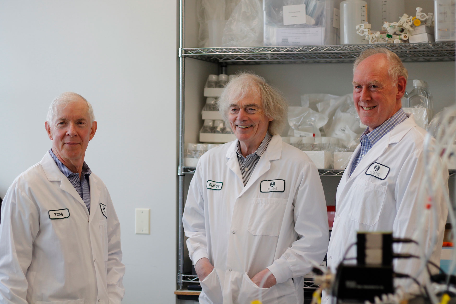 three people dressed in lab coats posing