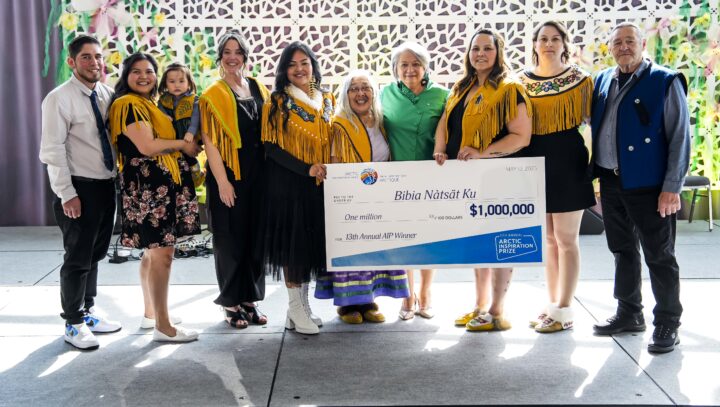 A winning team poses with a giant cheque.