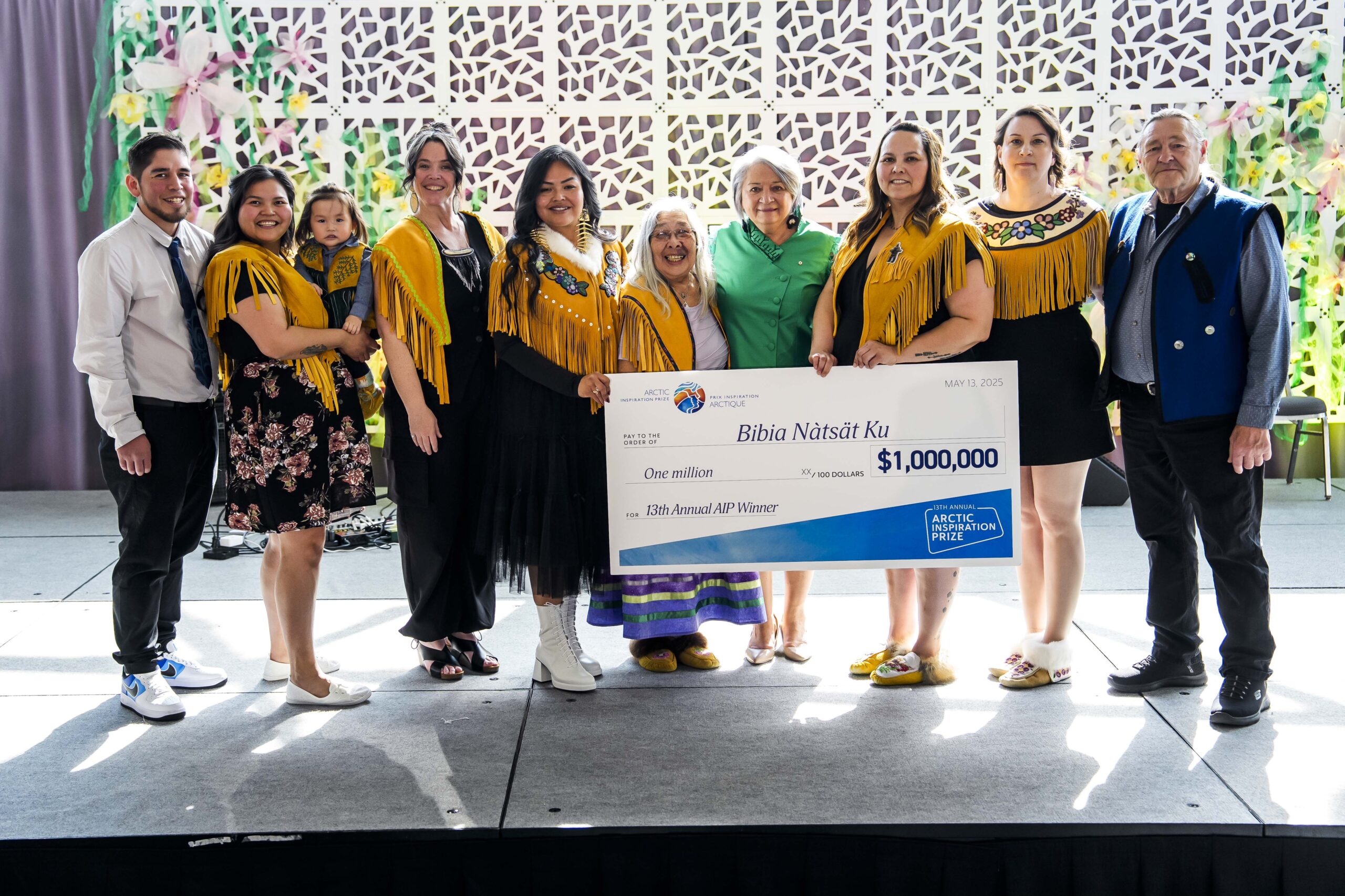A winning team poses with a giant cheque.