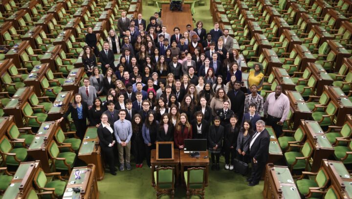 A group of young people pose inside the House of Commons.