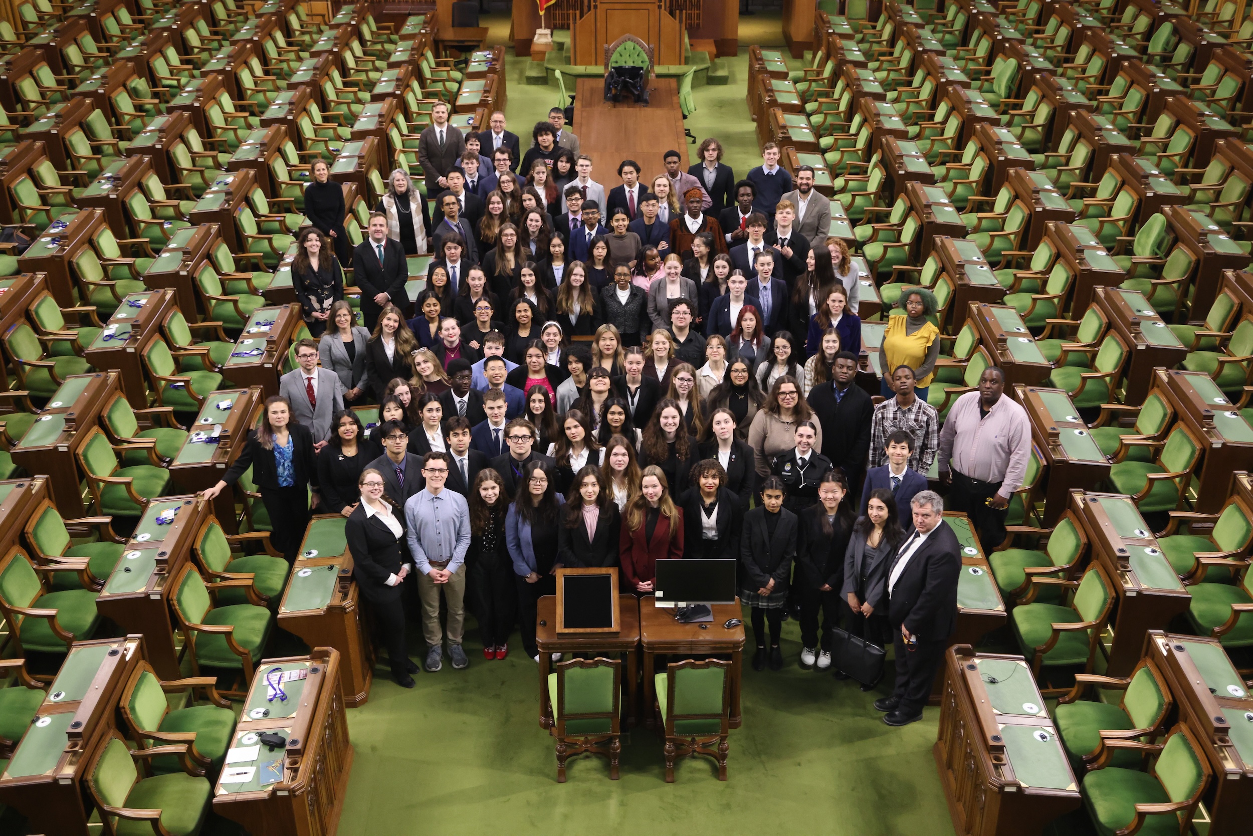 A group of young people pose inside the House of Commons.